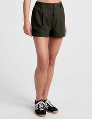 green shorts with side pockets and an elasticated waistband.