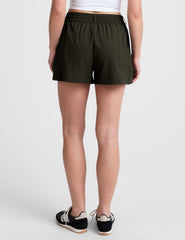 green shorts with side pockets and an elasticated waistband.