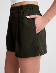 green shorts with side pockets and an elasticated waistband.