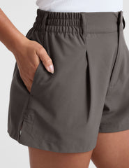 grey mid rise shorts with pockets and an elastic waistband with belt loops.