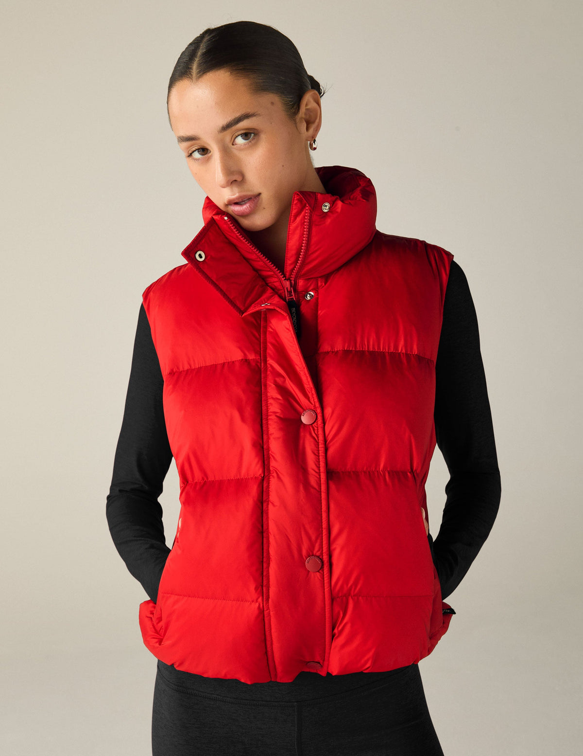 red button-up puffer vest with pockets.