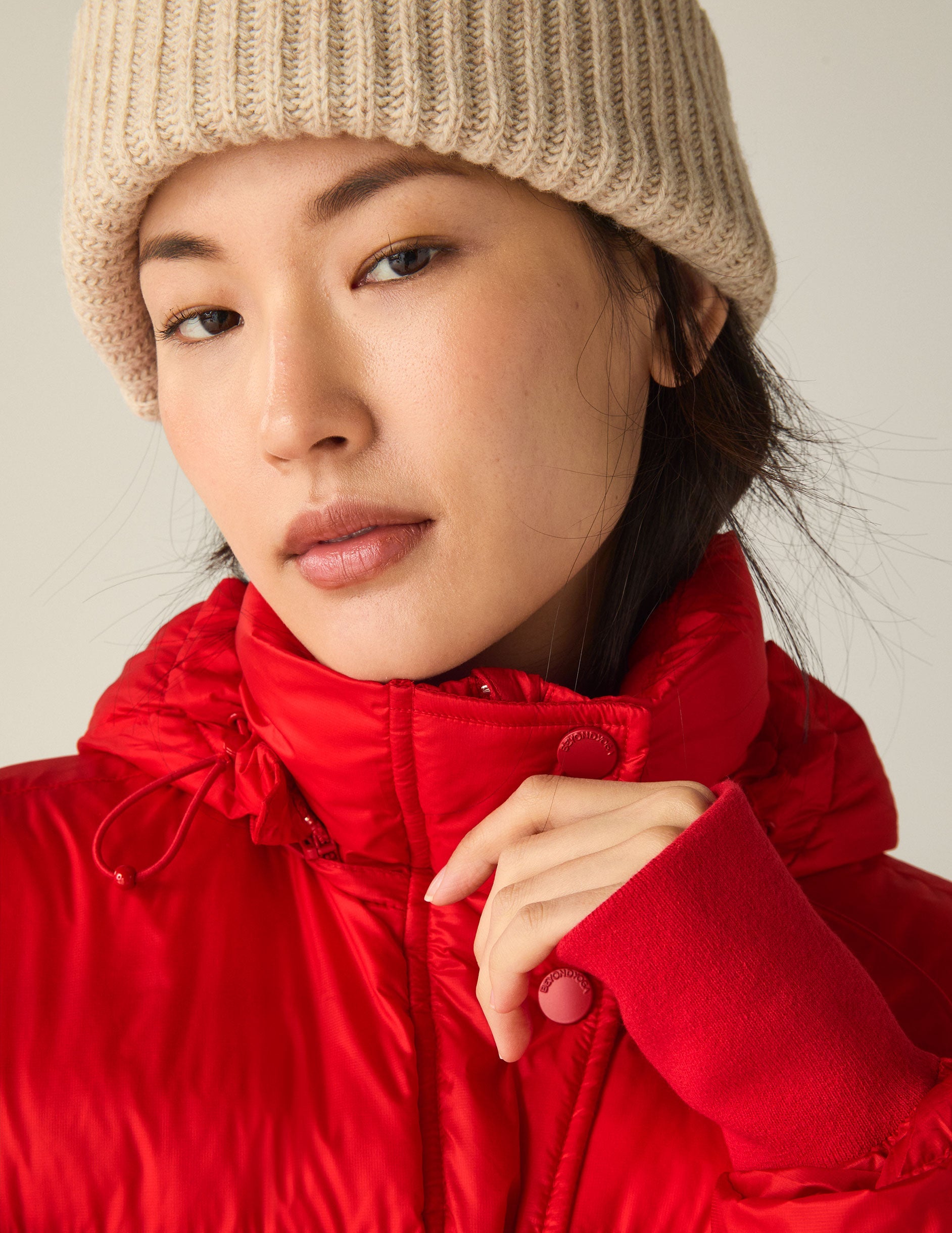 red hooded button & zip-up puffer jacket with pockets.