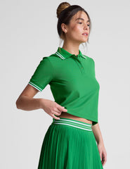green fitted polo style short sleeve t-shirt with a front placket with buttons and side slits.