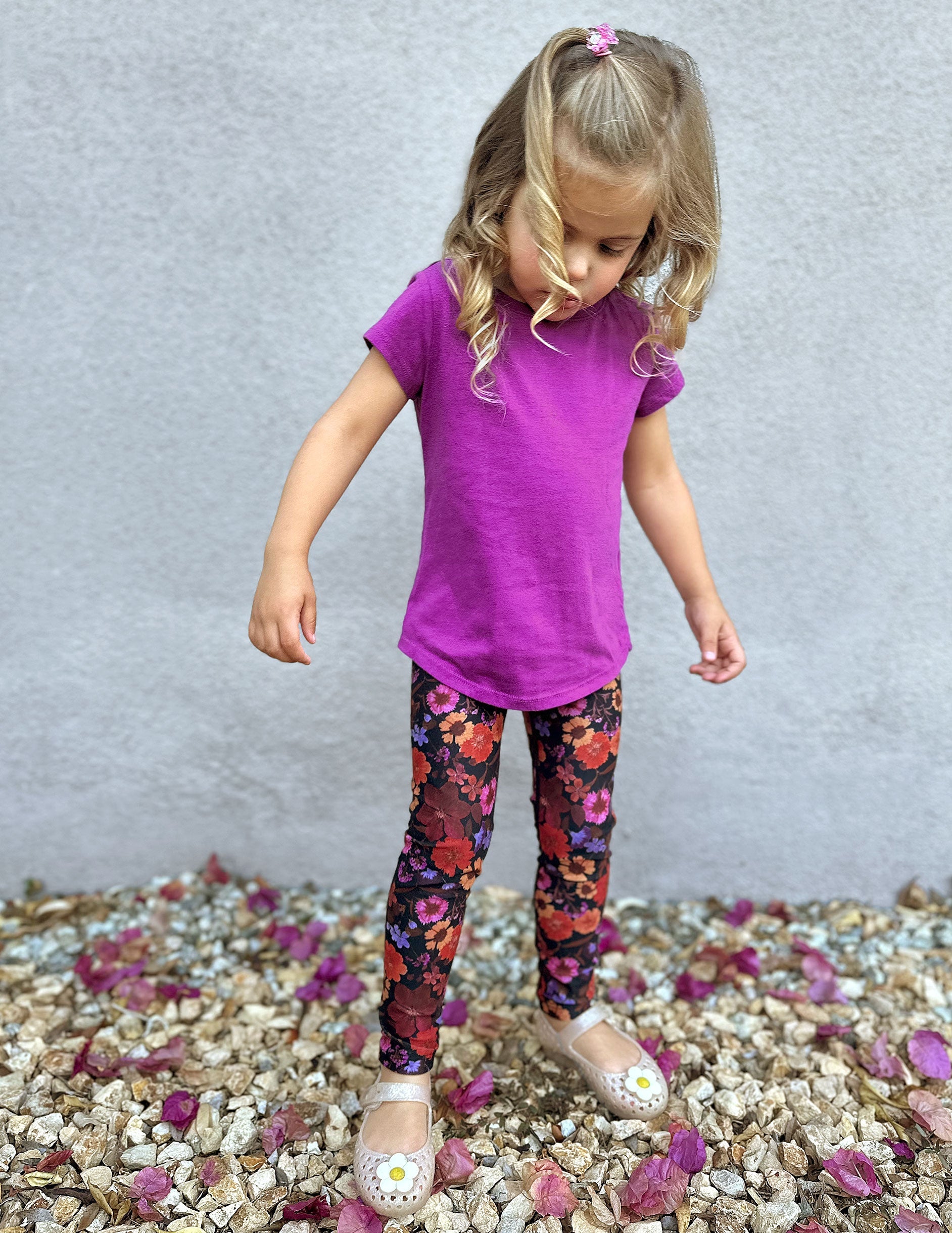 model is wearing toddler floral printed leggings.