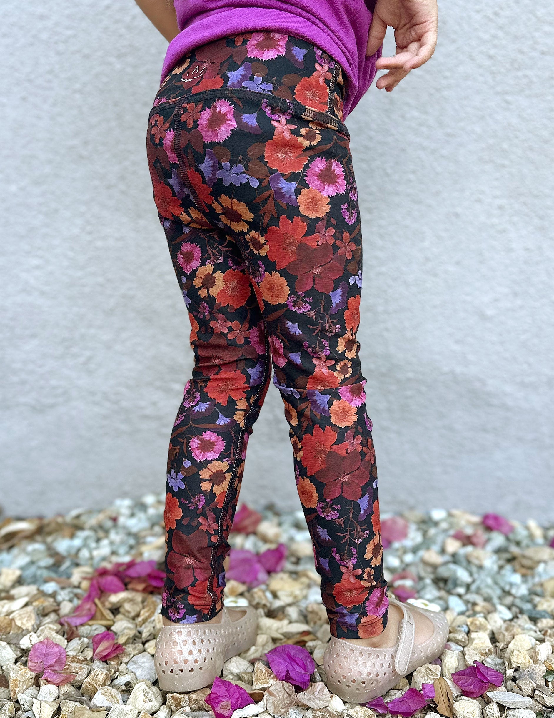 model is wearing toddler floral printed leggings.