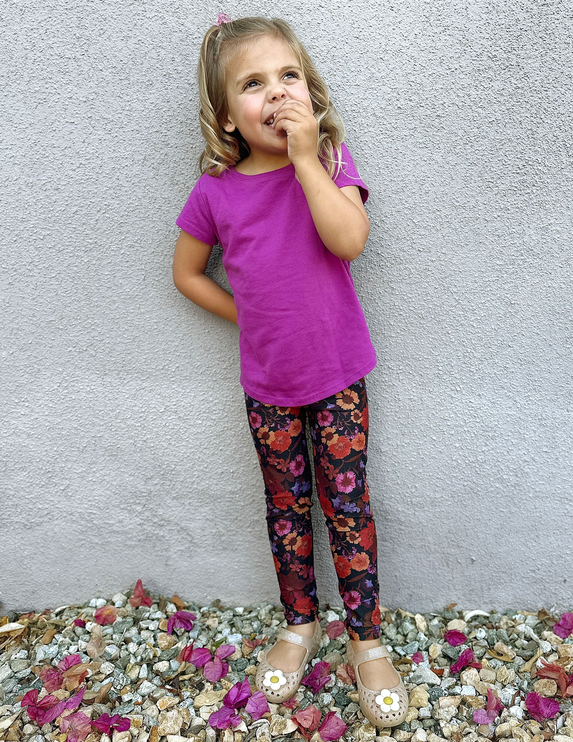 model is wearing toddler floral printed leggings.