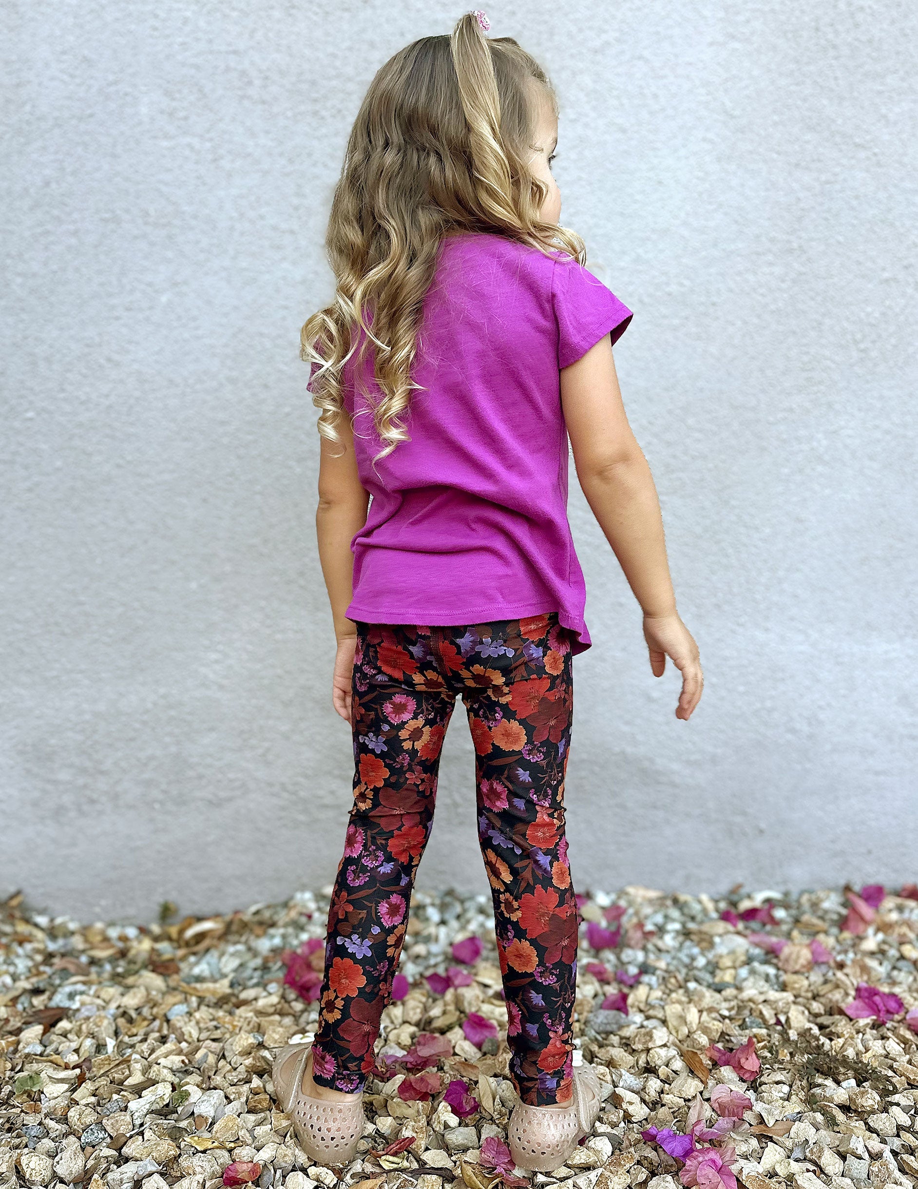 model is wearing toddler floral printed leggings.