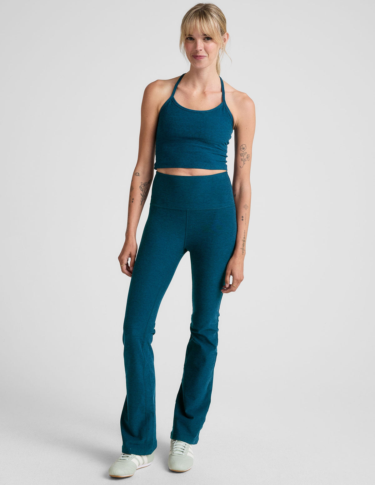 blue high-waisted bootcut pants.