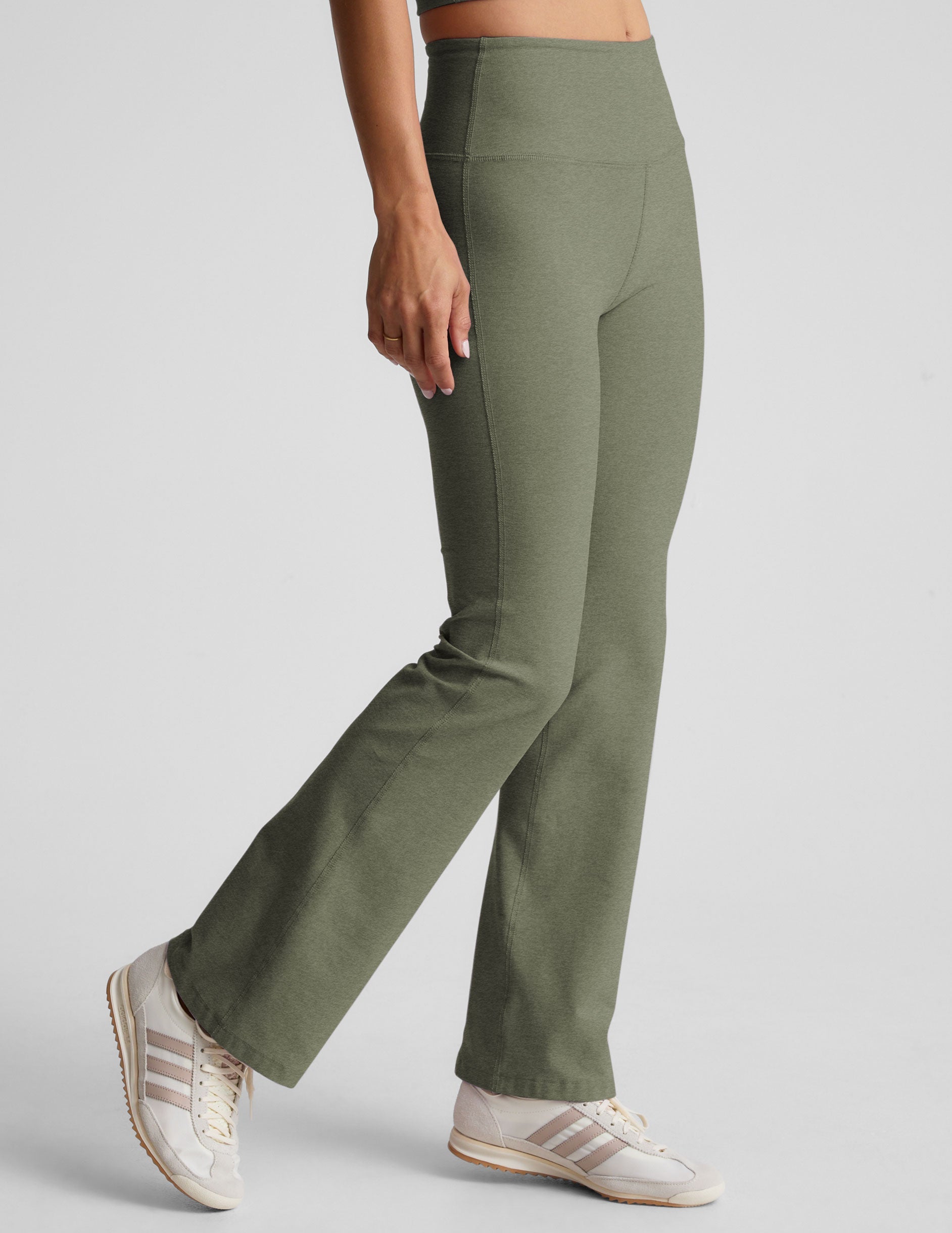 green high-waisted bootcut pants.
