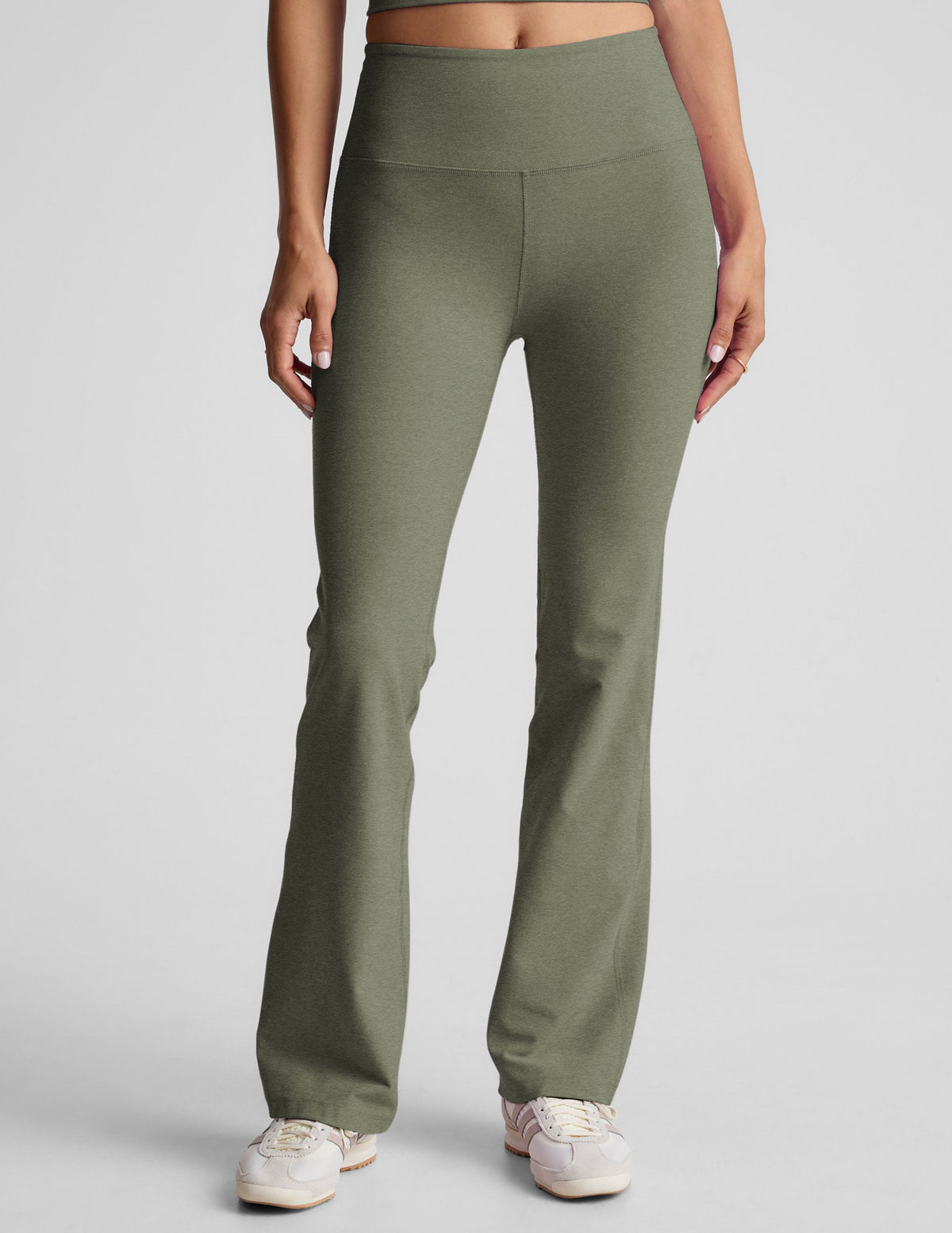 green high-waisted bootcut pants.