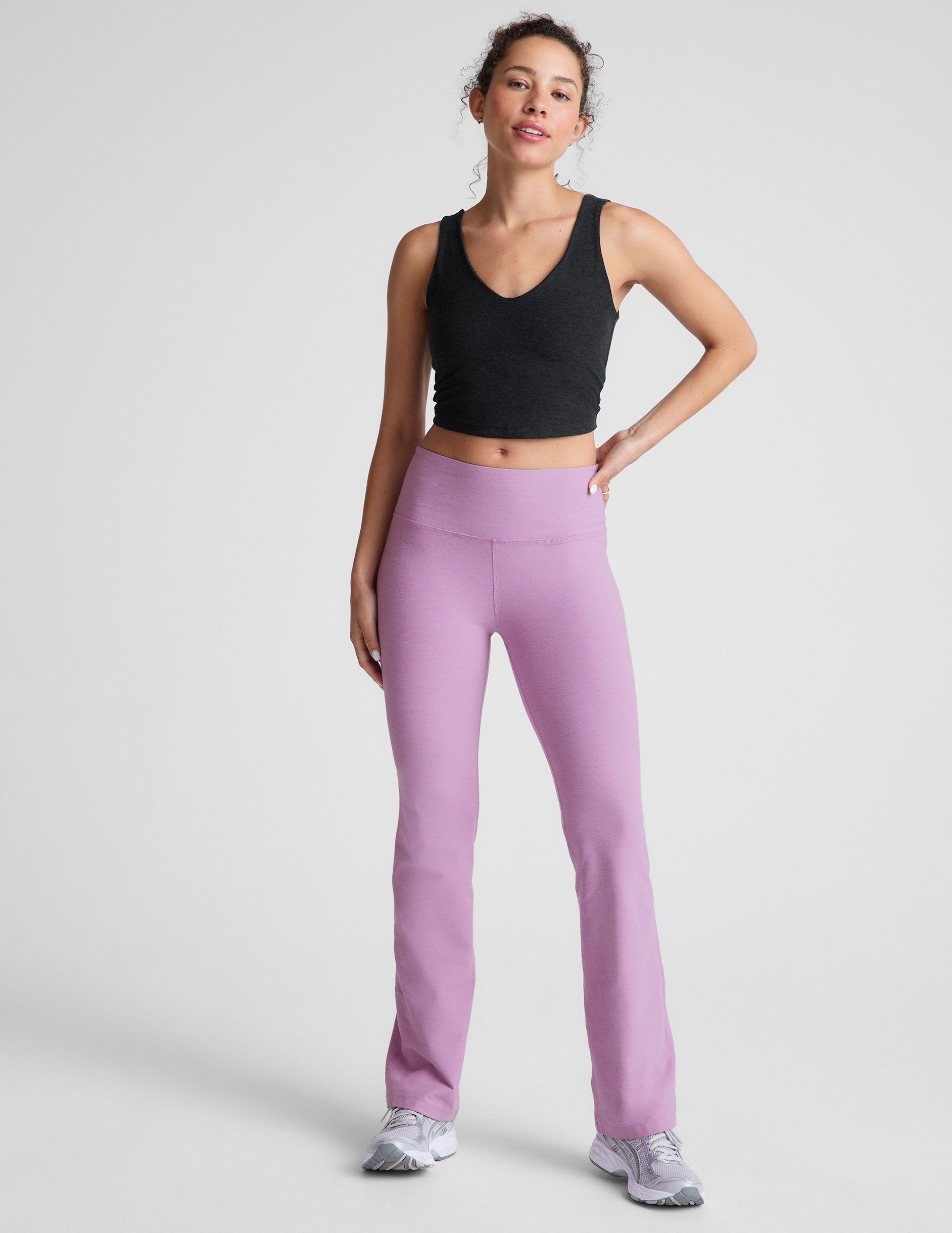 purple high-waisted bootcut pants.