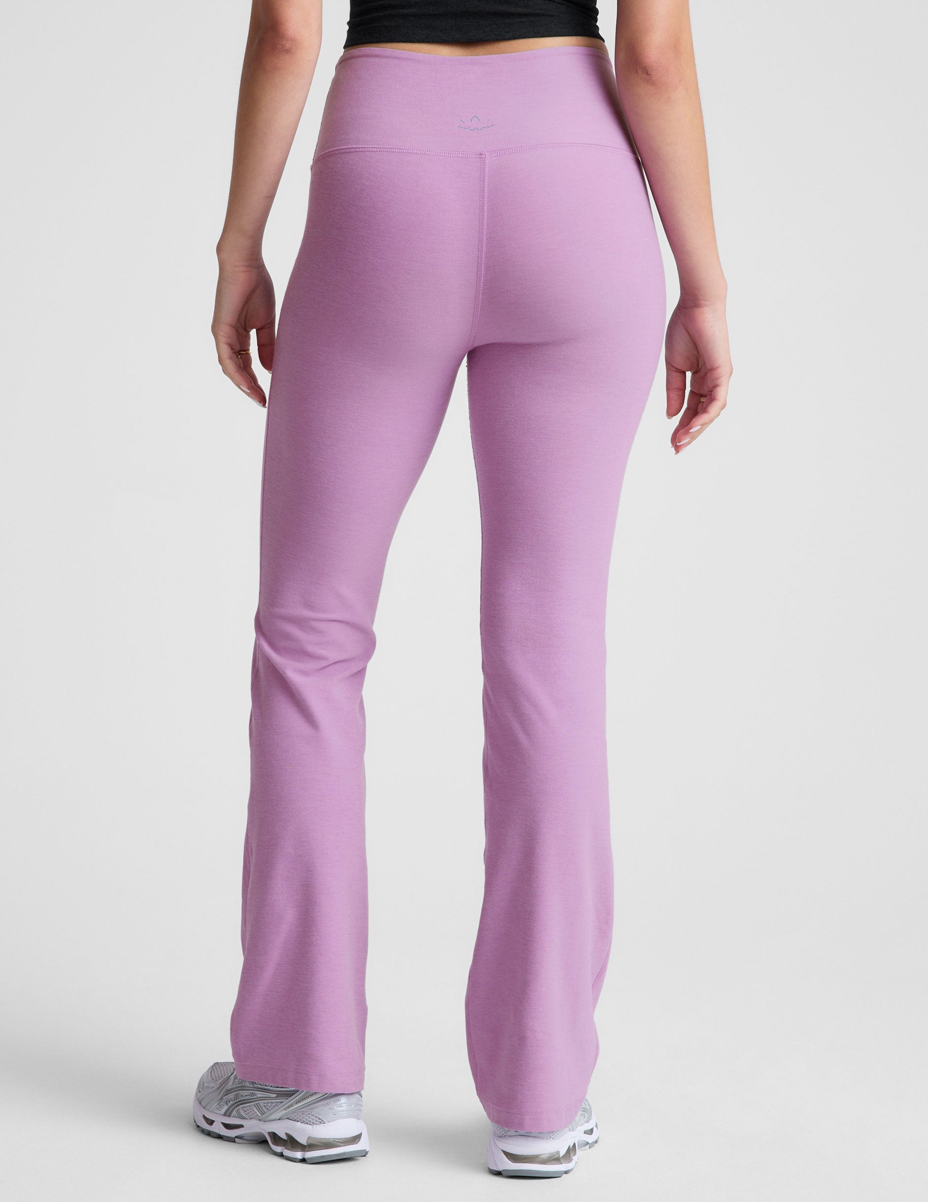 purple high-waisted bootcut pants.