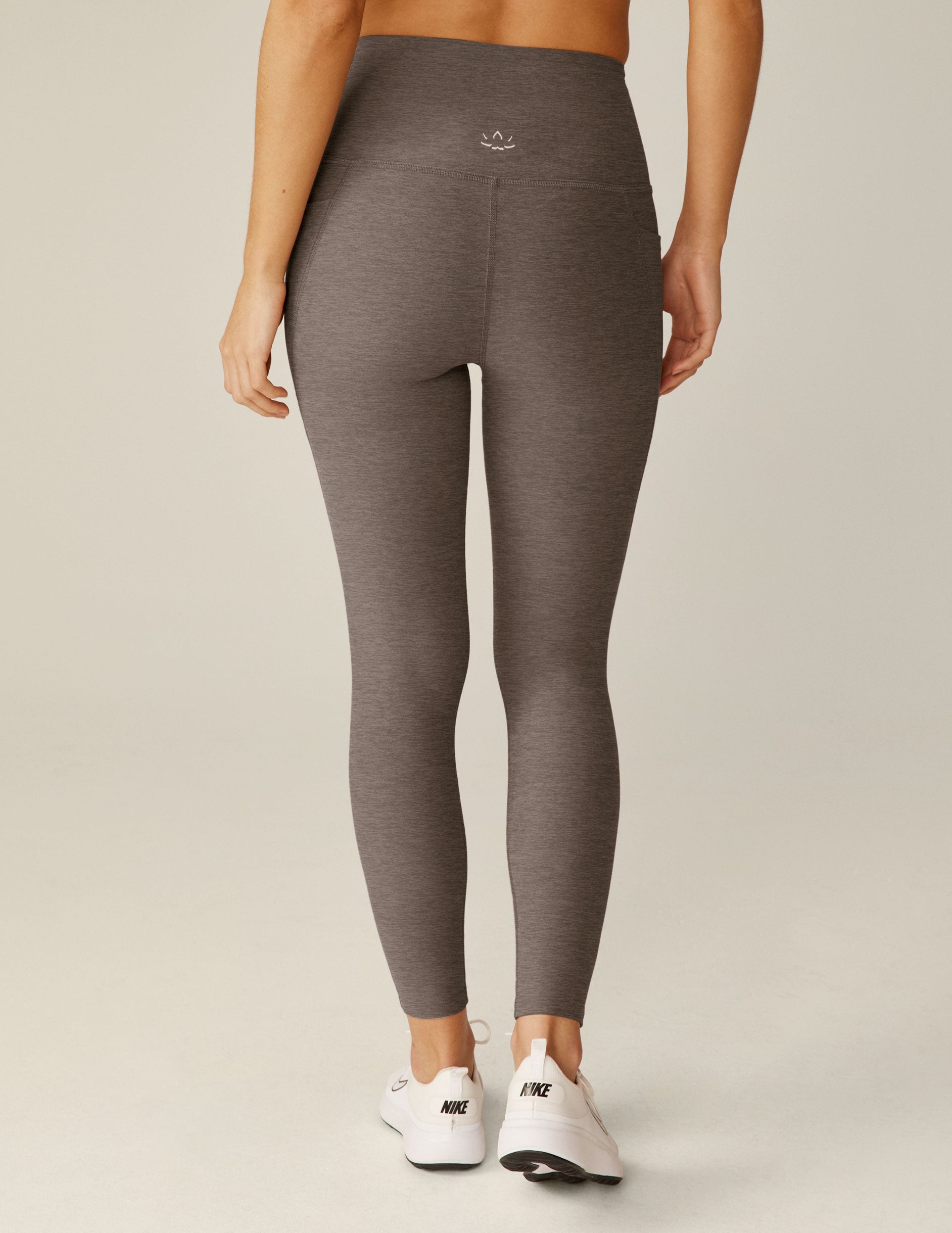 brown high-waisted midi leggings with pockets.
