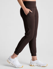 brown high-waisted midi length joggers with pockets.