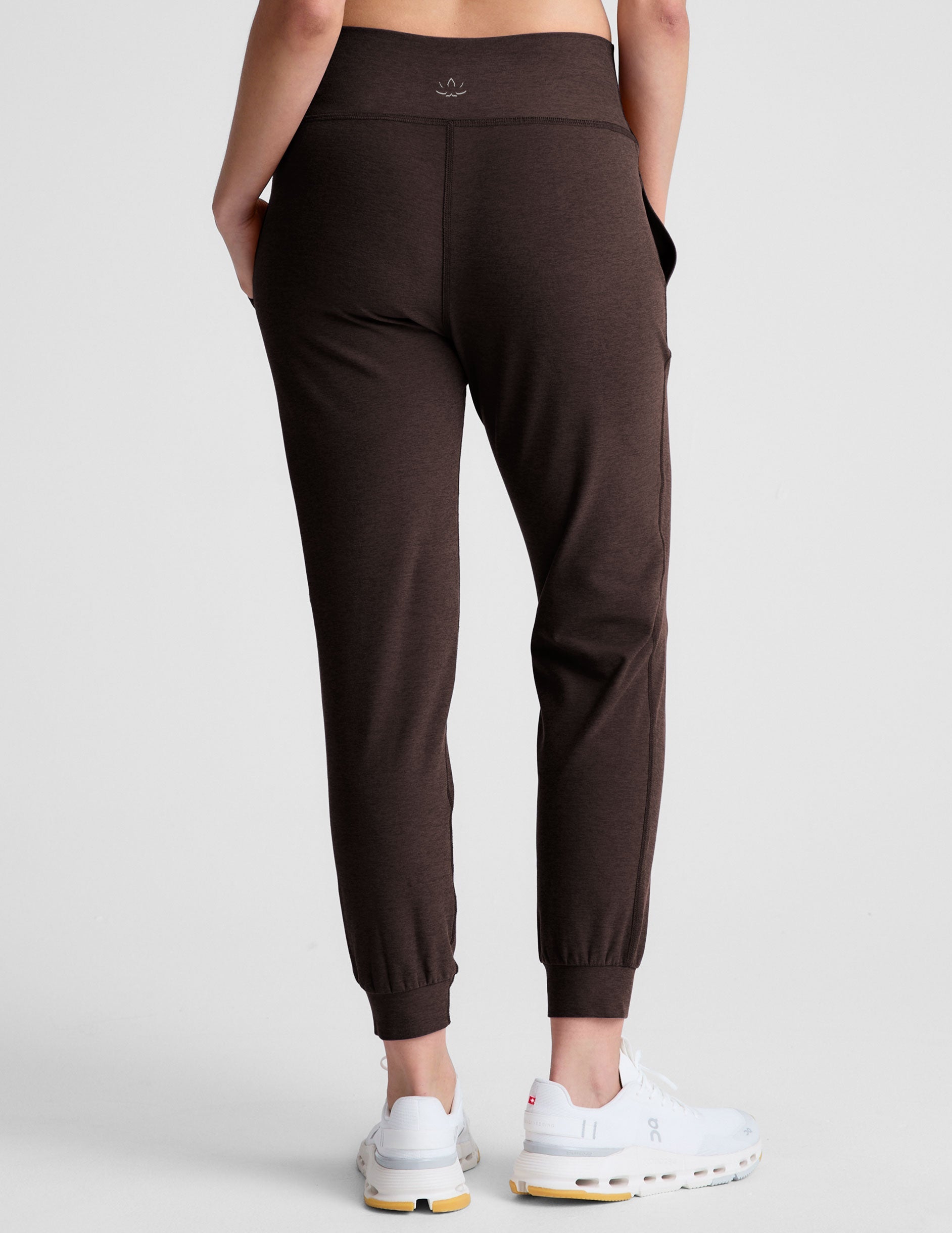 brown high-waisted midi length joggers with pockets.
