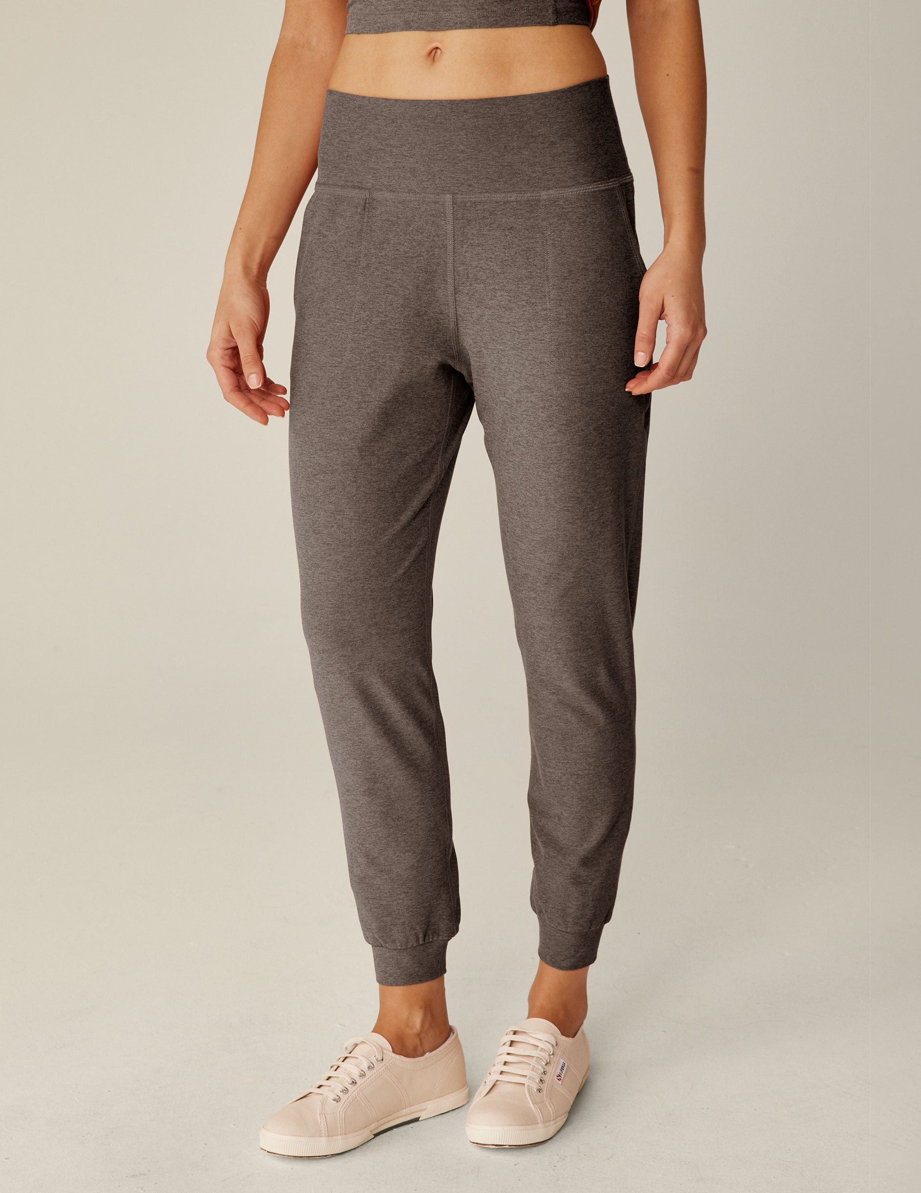 brown high-waisted midi length joggers with pockets.