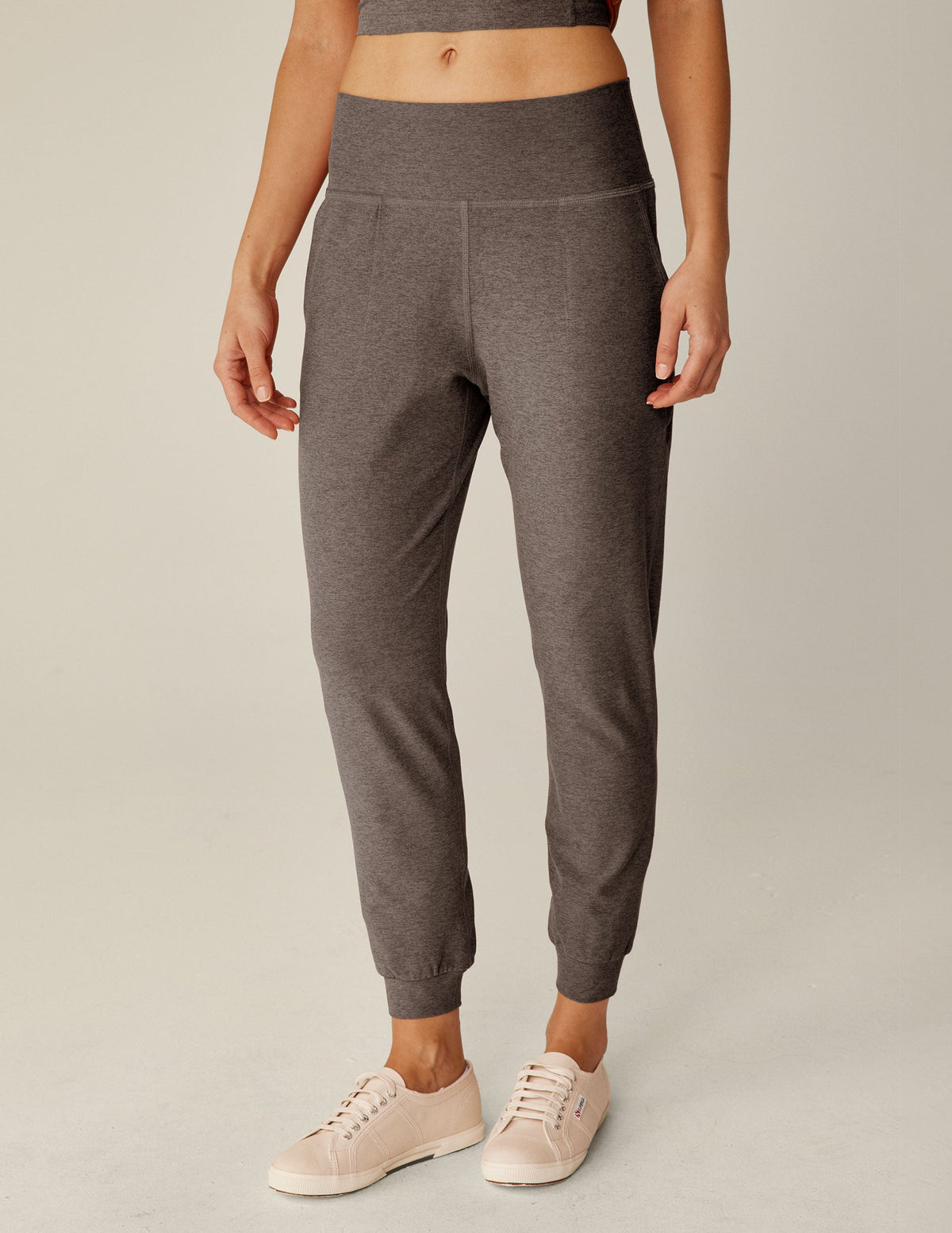 brown high-waisted midi length joggers with pockets.