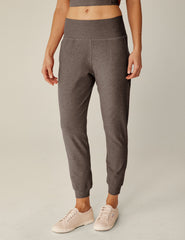brown high-waisted midi length joggers with pockets.