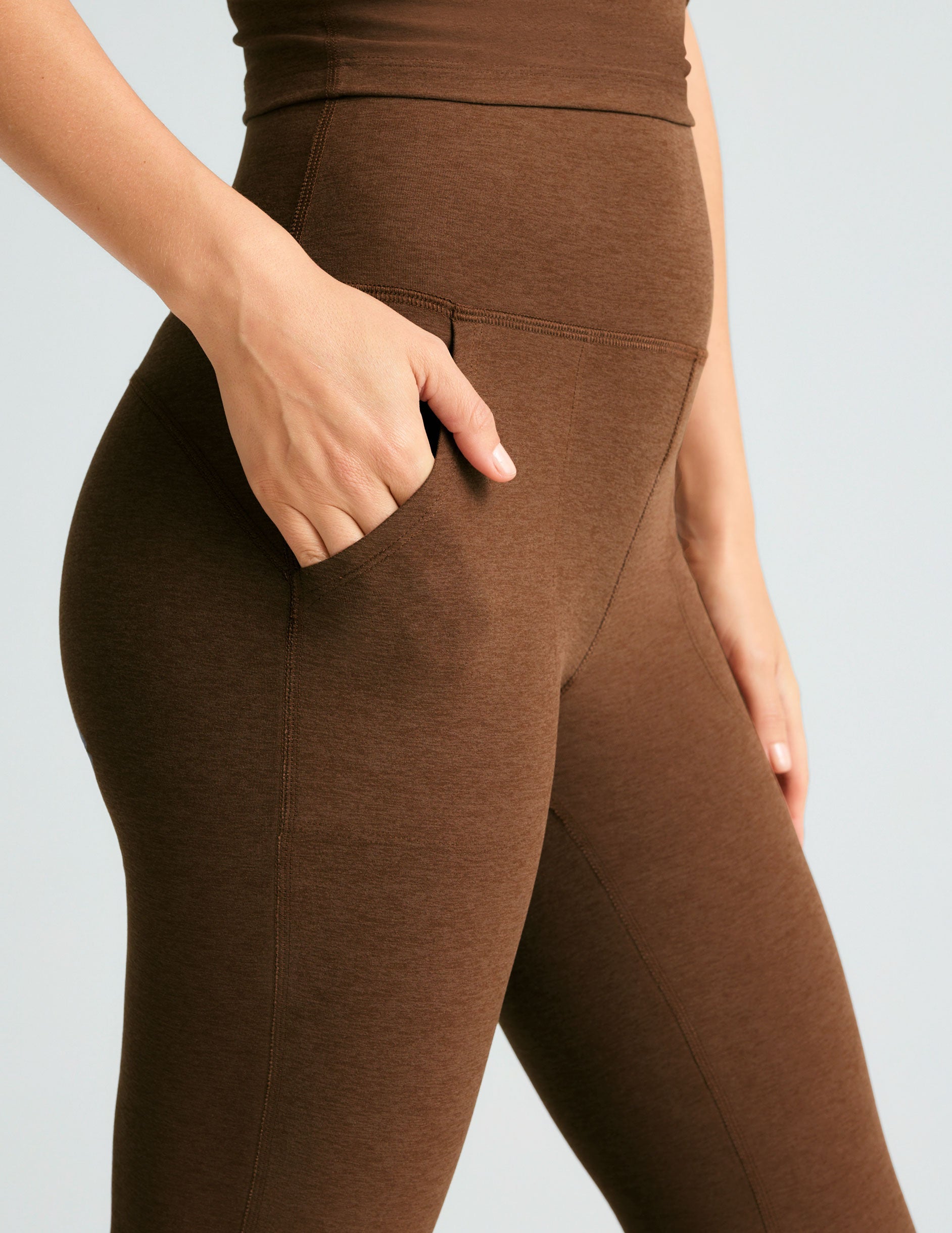 brown high-waisted flare pants with side pockets.