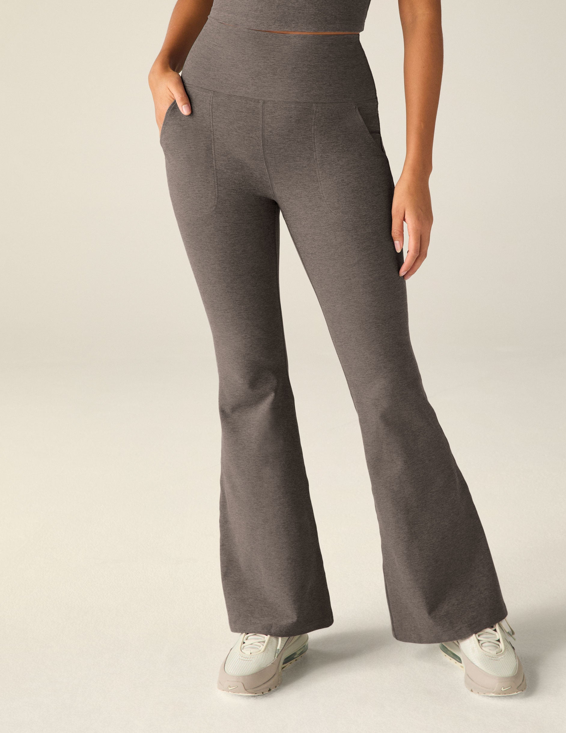 brown high-waisted flare pants with pockets.
