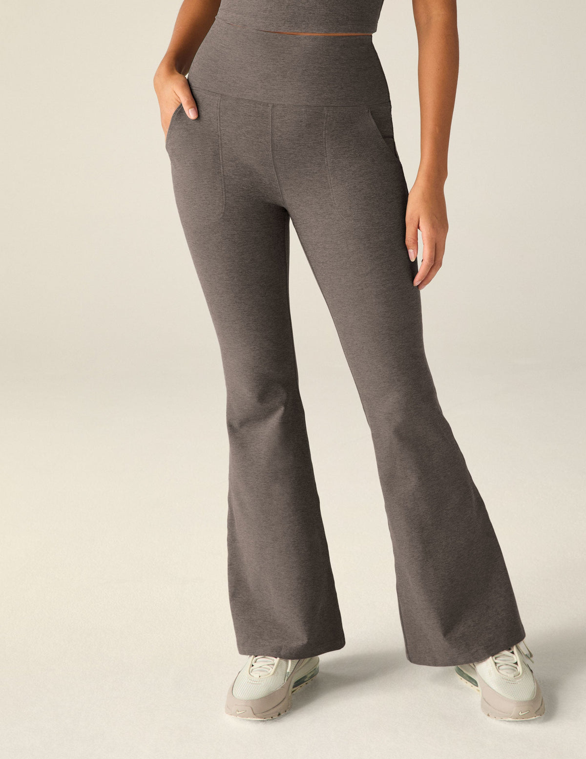 brown high-waisted flare pants with pockets.