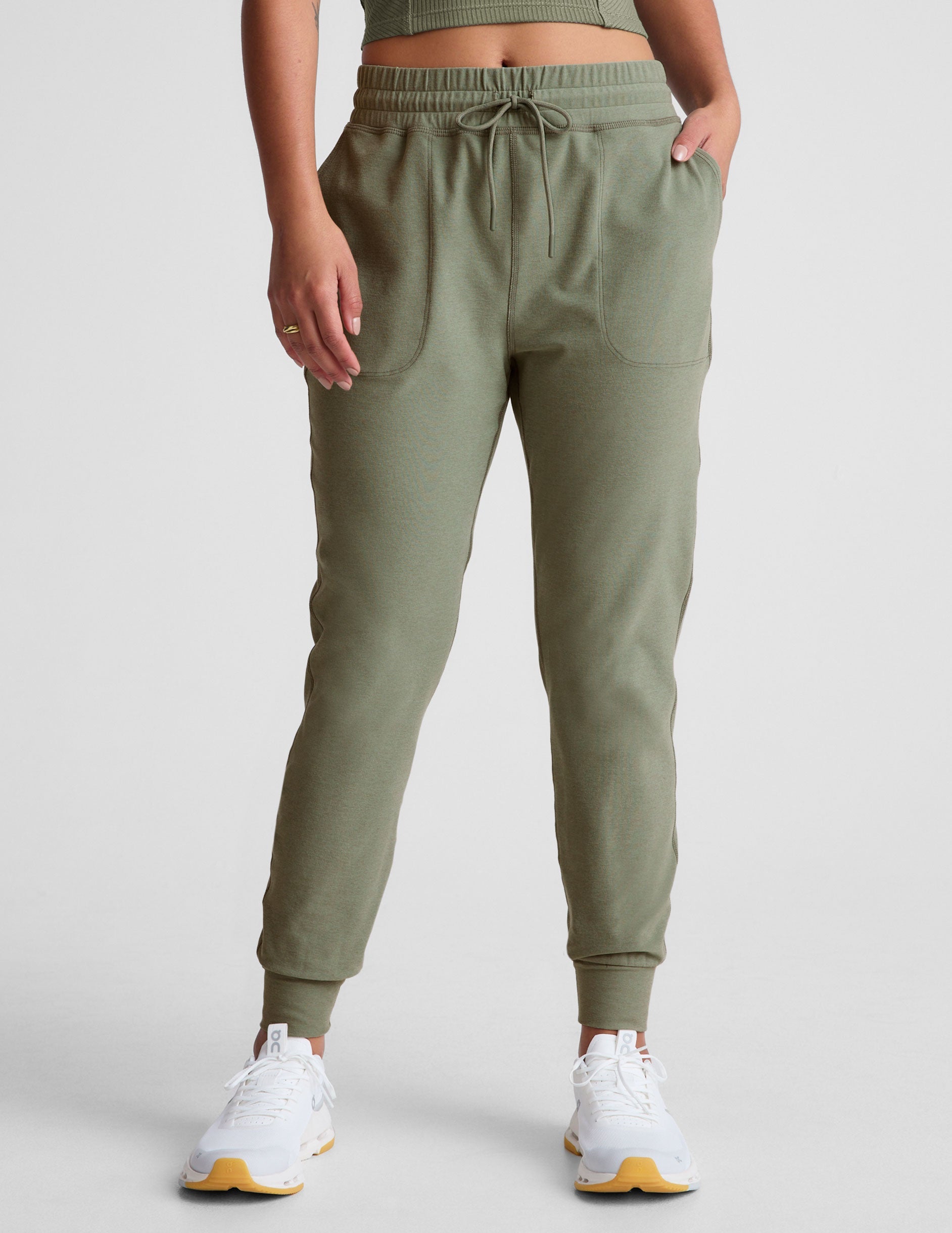 green midi length joggers with a drawstring in waistband and pockets.
