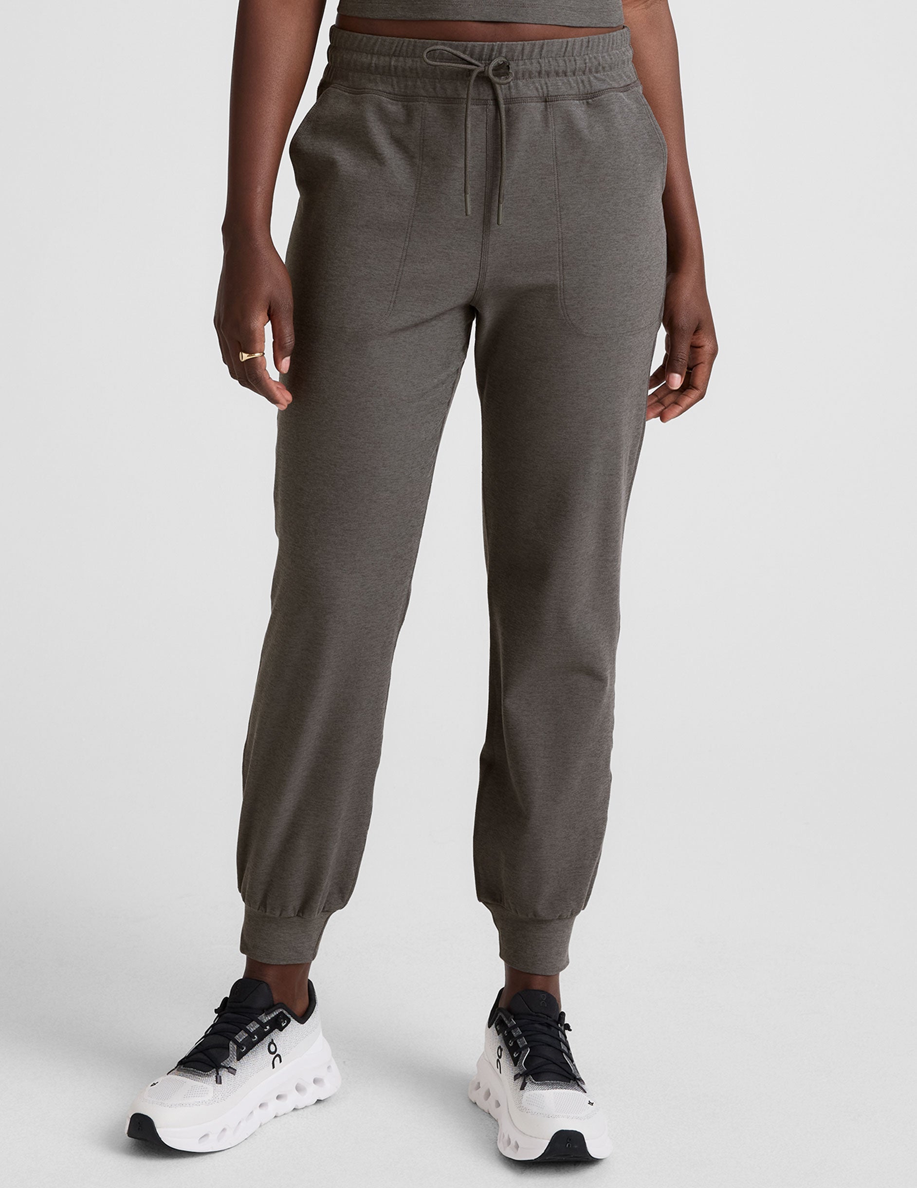 grey joggers with side pockets and a drawstring at waistband.