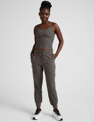 grey joggers with side pockets and a drawstring at waistband.