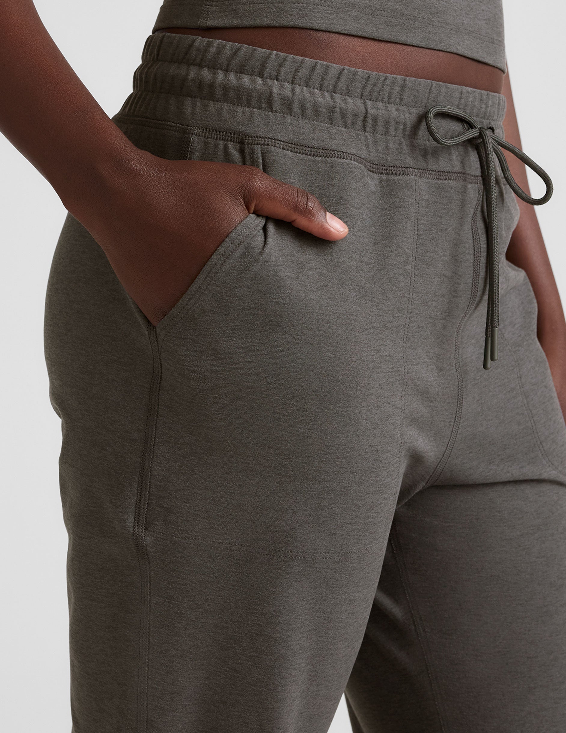grey joggers with side pockets and a drawstring at waistband.