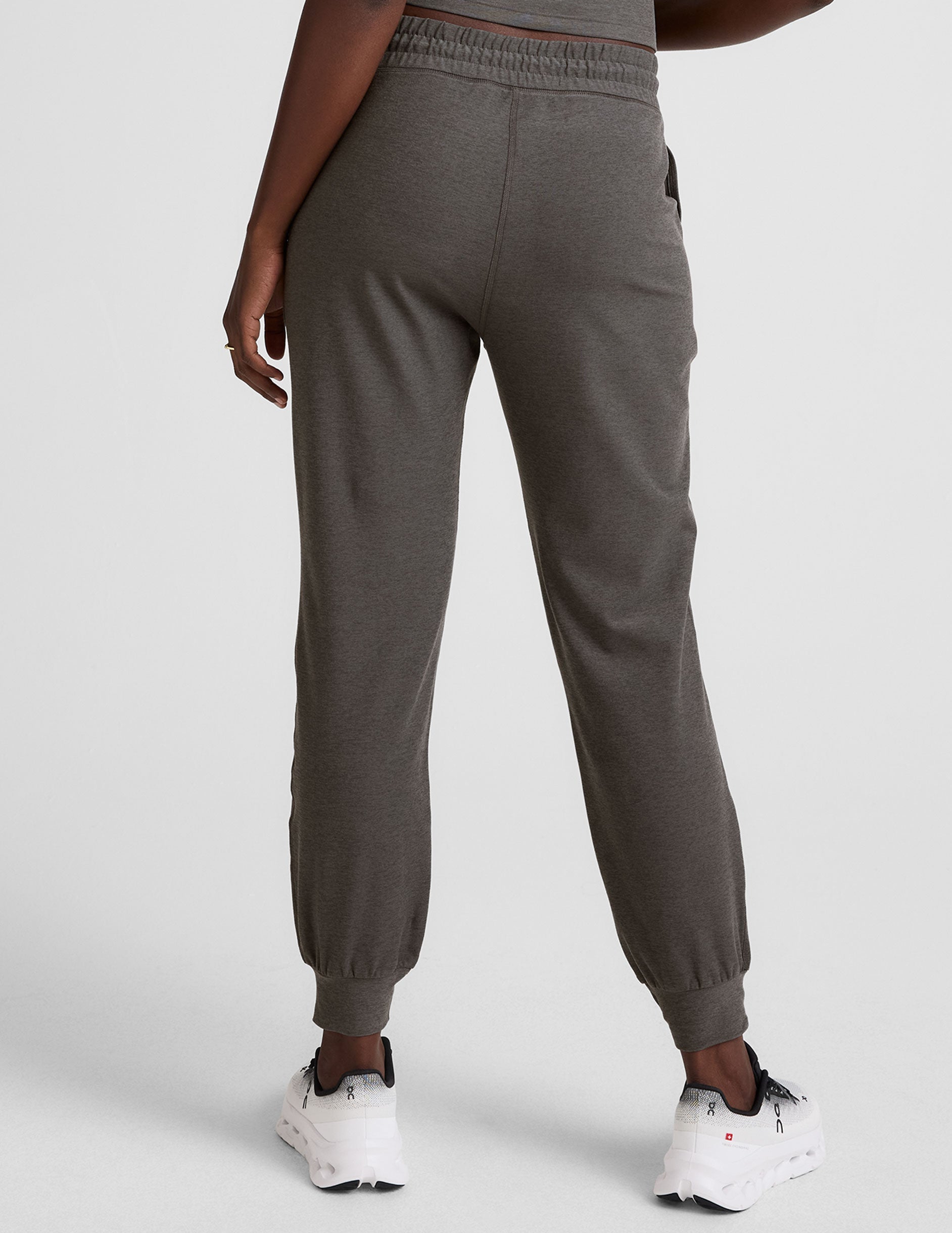 grey joggers with side pockets and a drawstring at waistband.