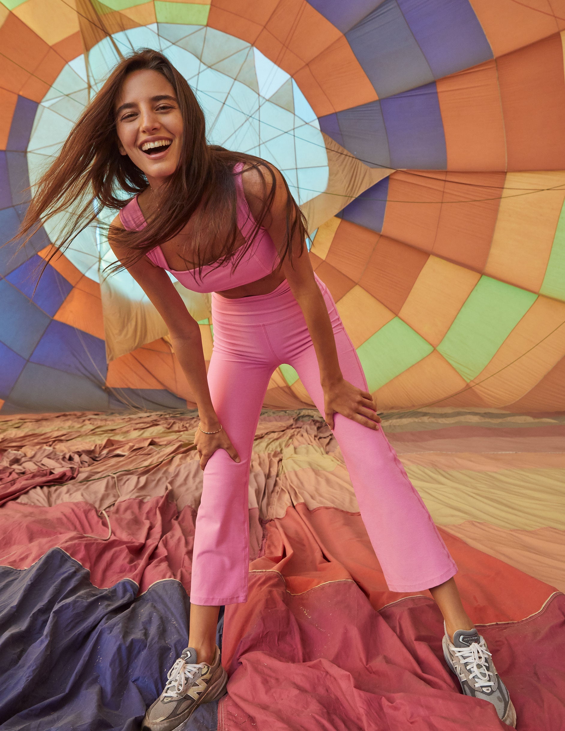 model is wearing pink high-waisted high-rise pants.