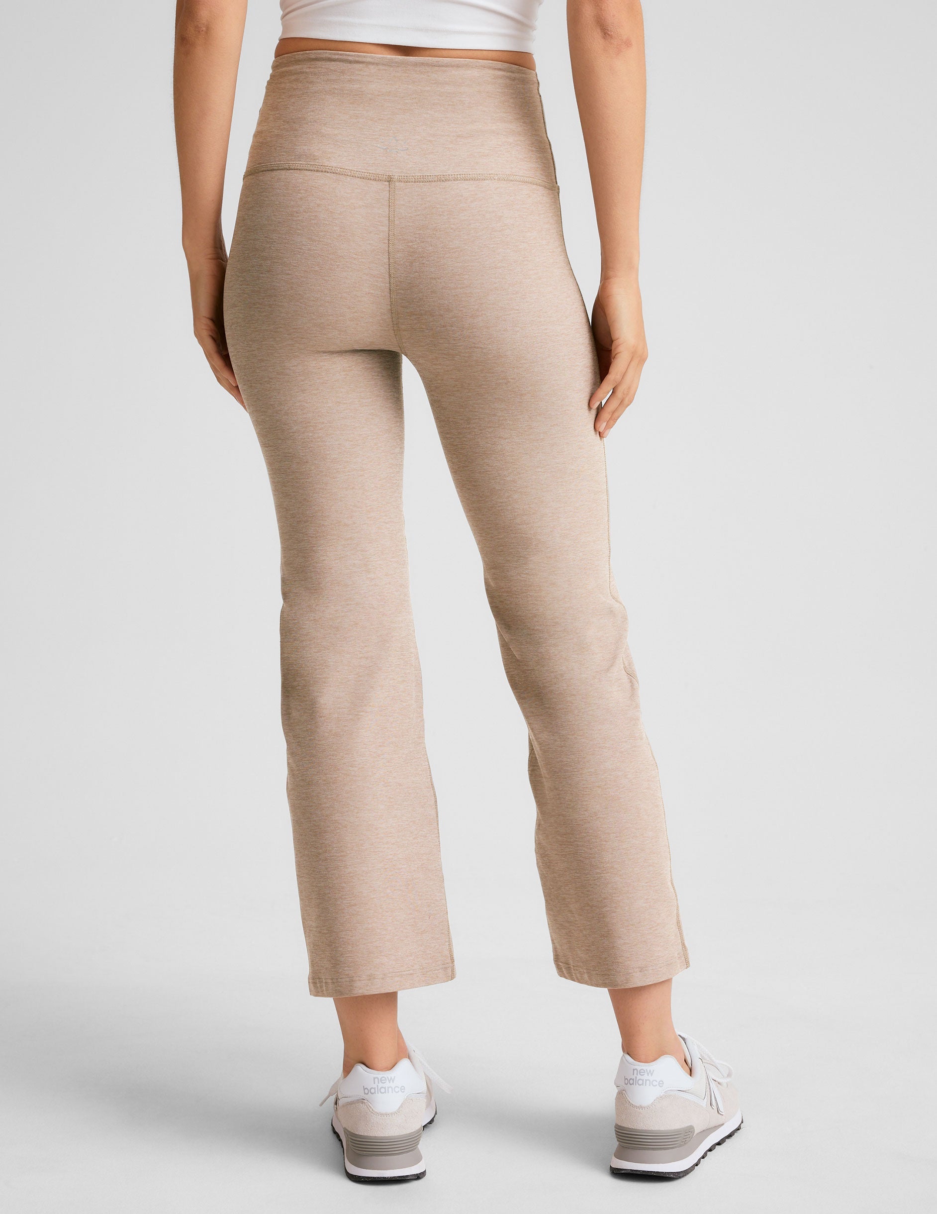light brown high-waisted cropped flare pants.