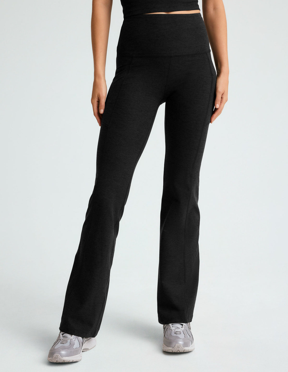 black high-waisted flare leggings with front side pockets.