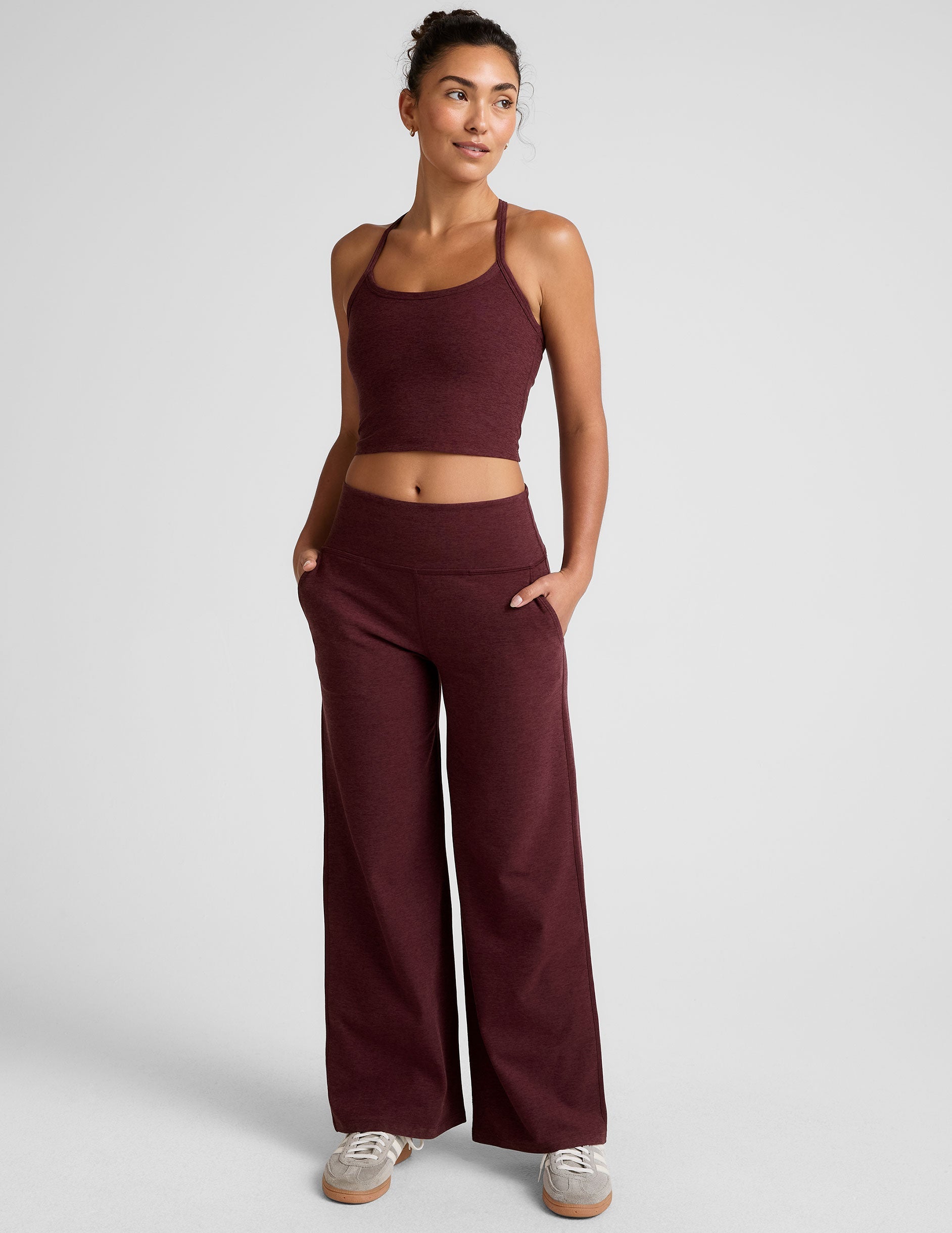 model is wearing red mid-rise wide leg pants with pockets.