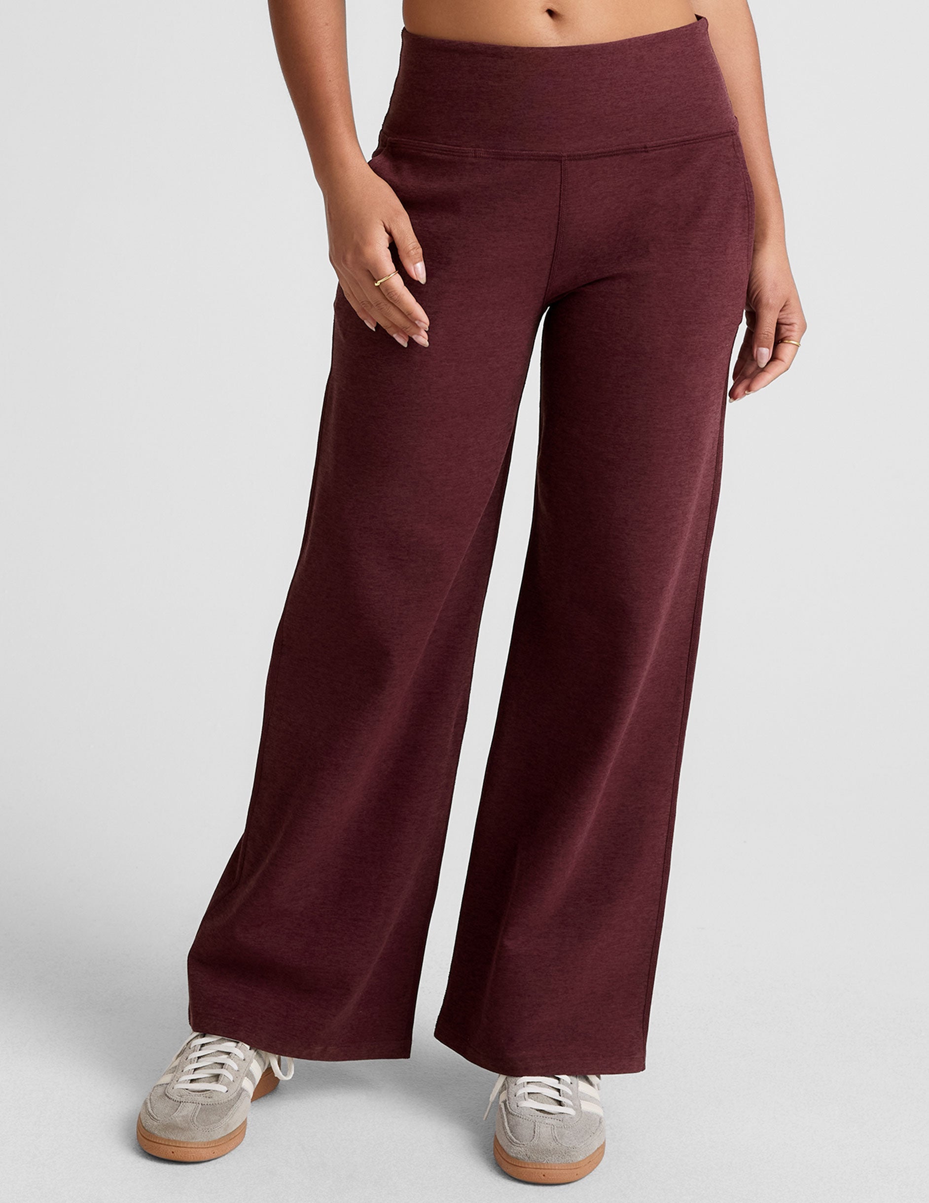 model is wearing red mid-rise wide leg pants with pockets.