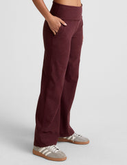 model is wearing red mid-rise wide leg pants with pockets.