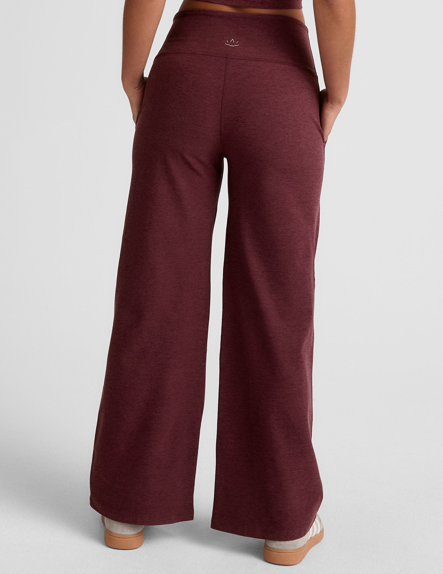 model is wearing red mid-rise wide leg pants with pockets.