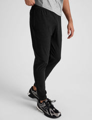 black jogger pants on a plain background.