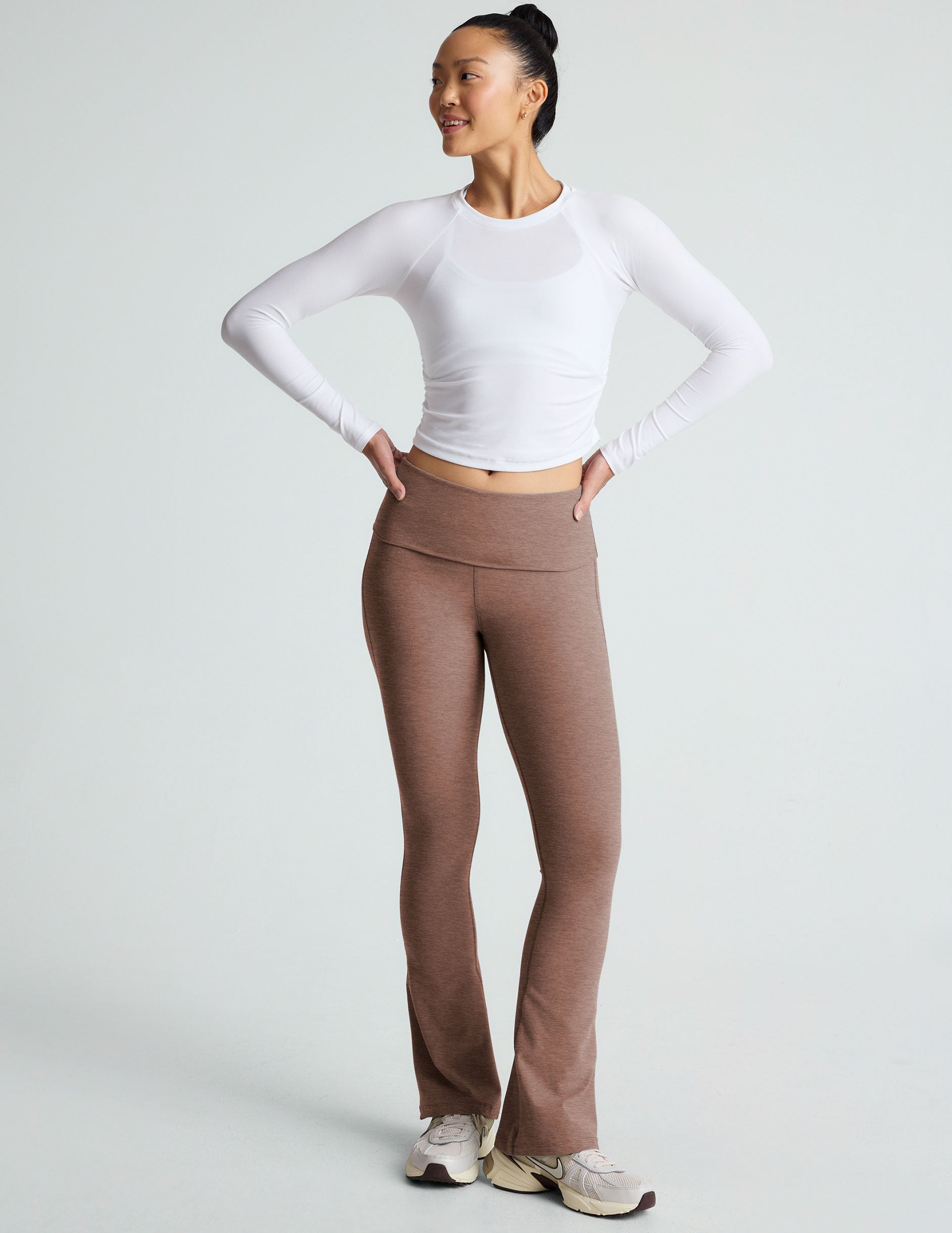 brown high-waisted bootcut flare leggings with a foldover waistband.