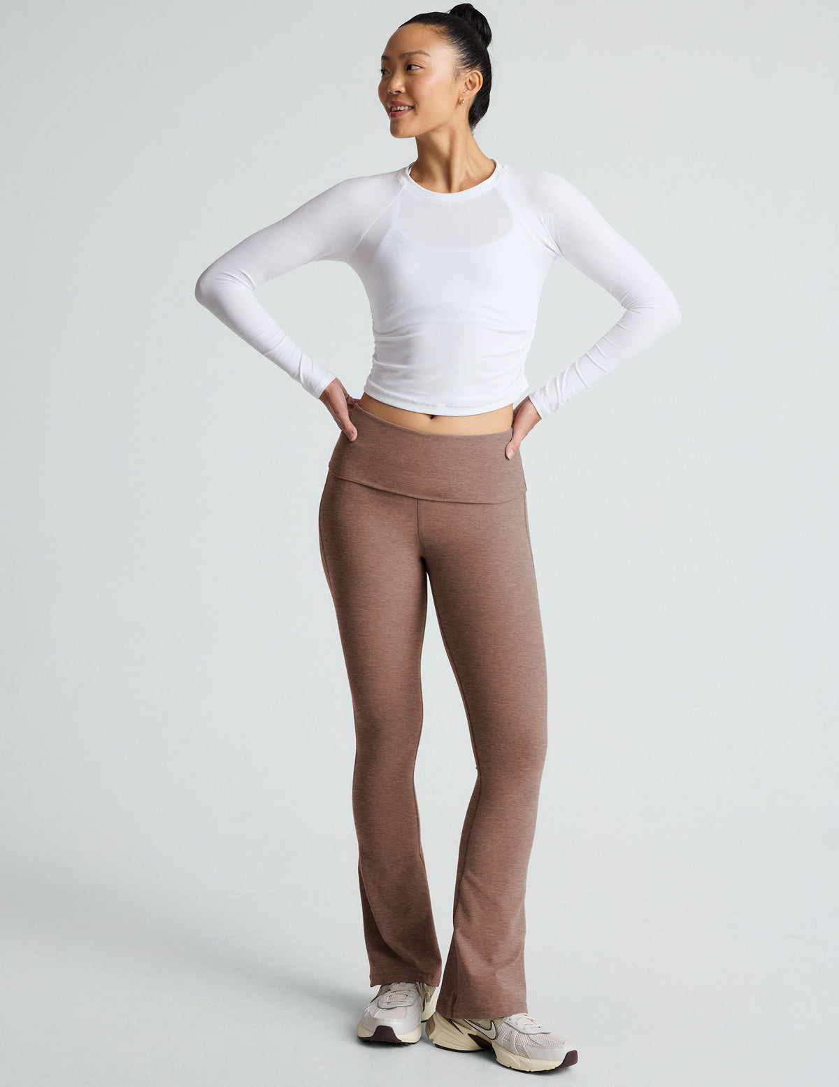 brown high-waisted bootcut flare leggings with a foldover waistband.