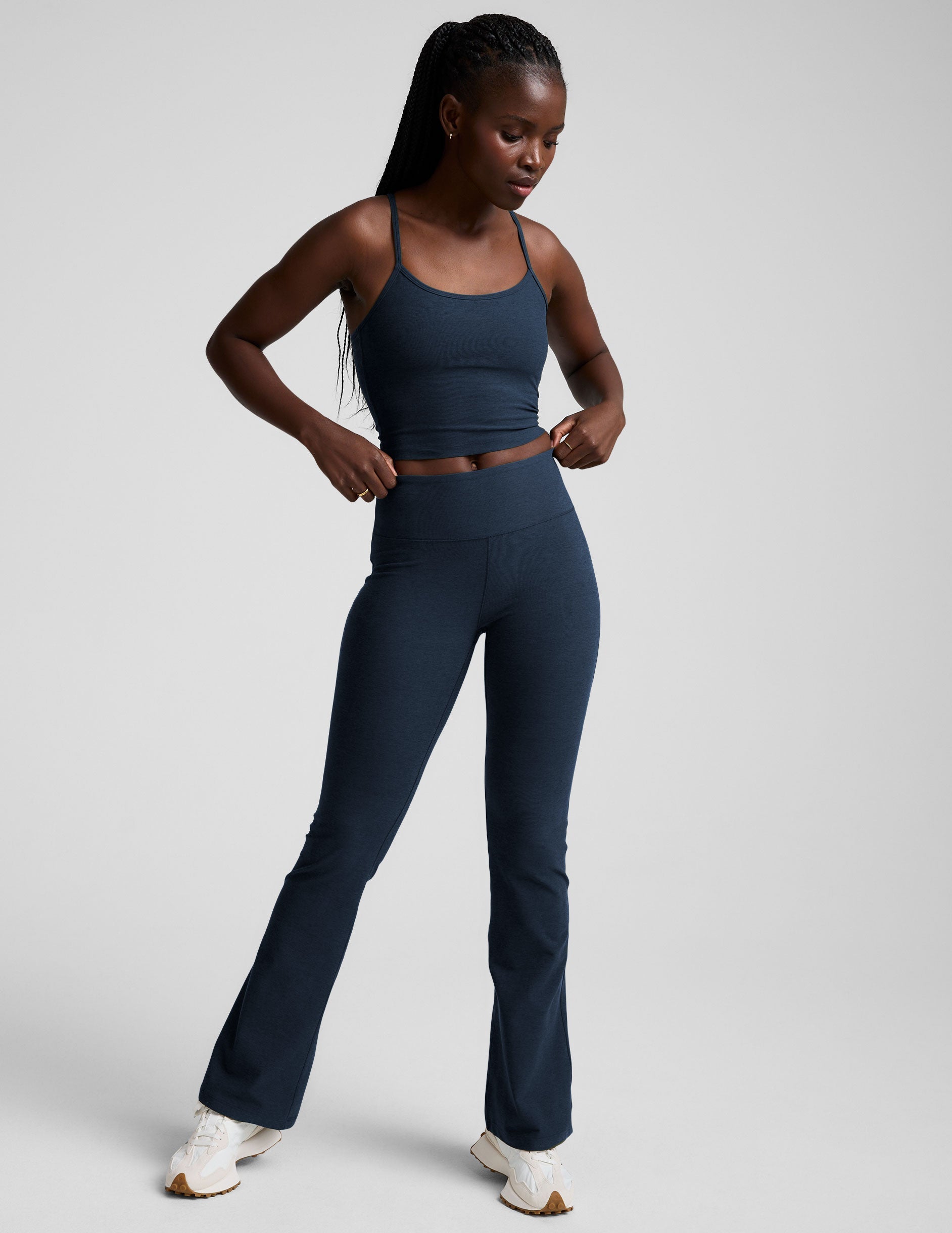 navy blue pants worn by a person on a light gray background.