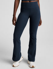 navy blue pants worn by a person on a light gray background.
