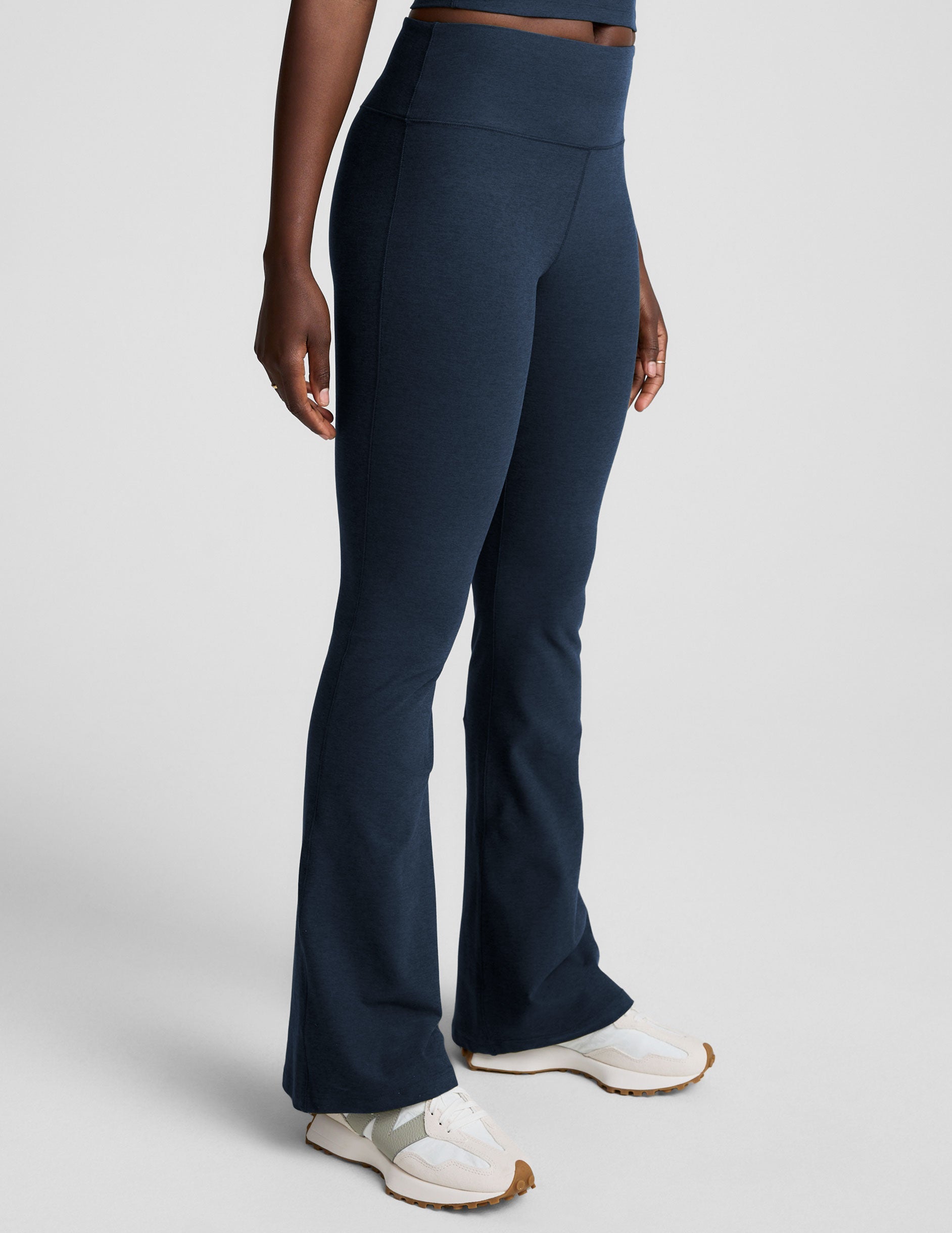 navy blue pants worn by a person on a light gray background.