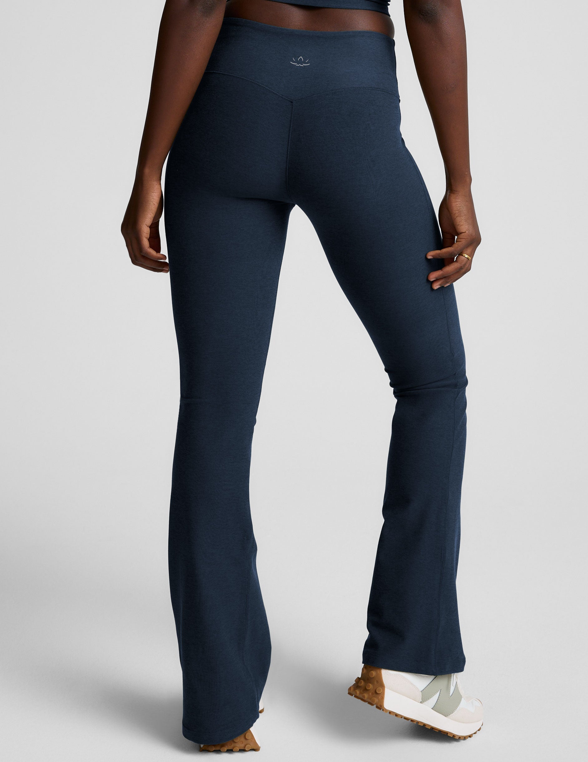 navy blue pants worn by a person on a light gray background.
