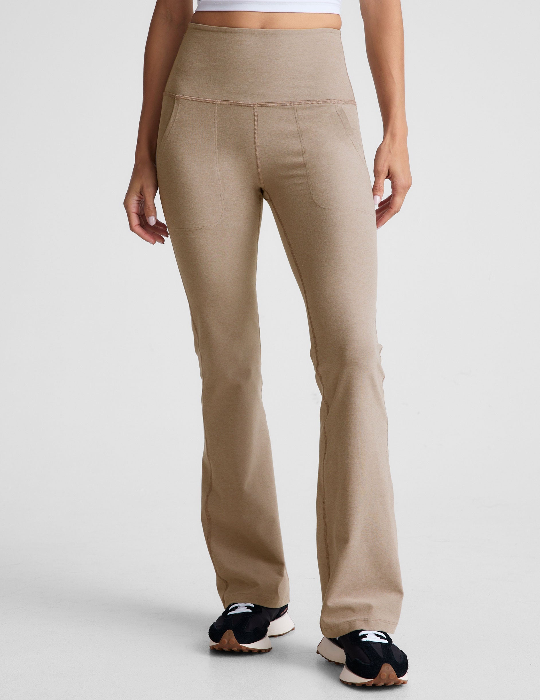brown high-waisted bootcut pants with side pockets.