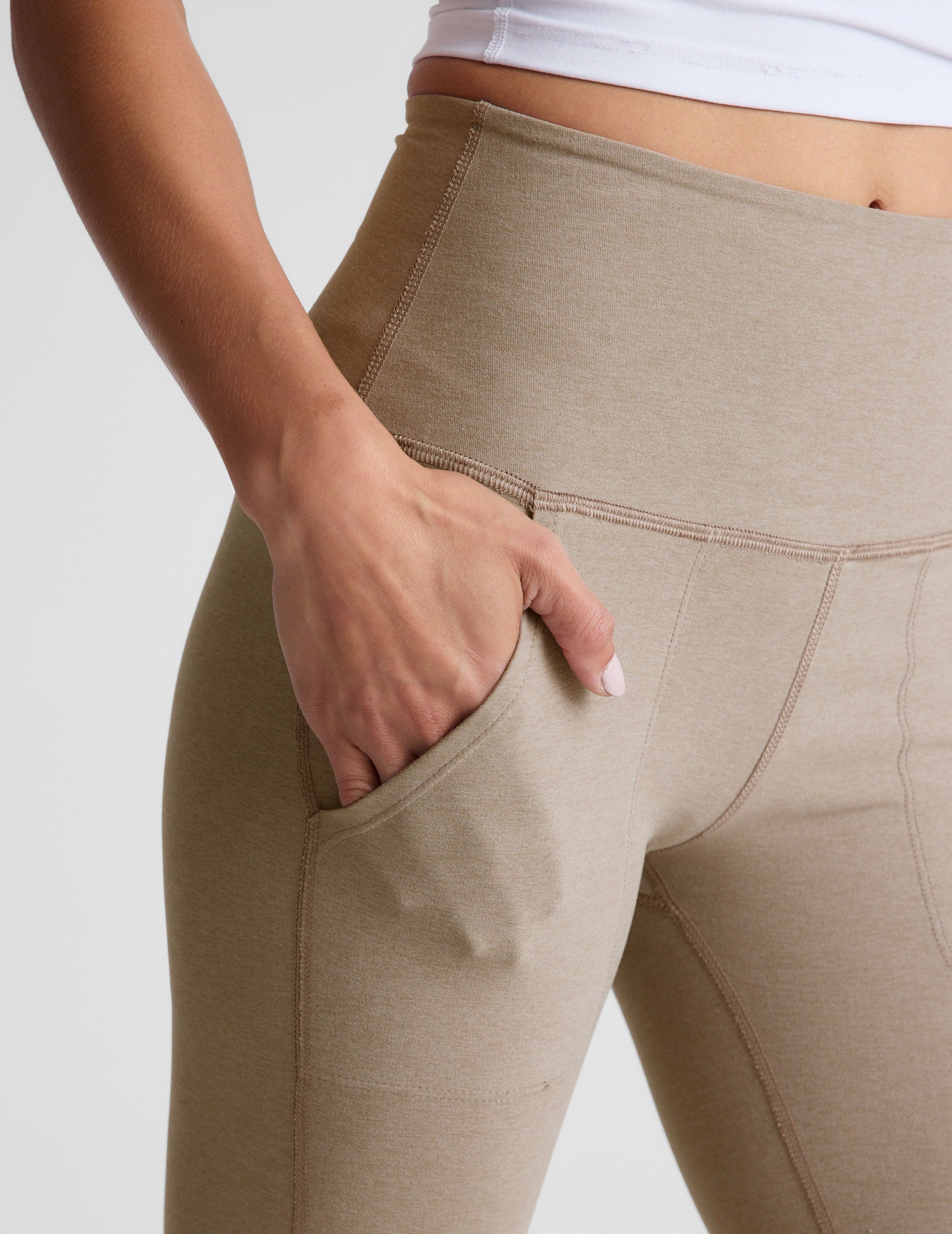 brown high-waisted bootcut pants with side pockets.