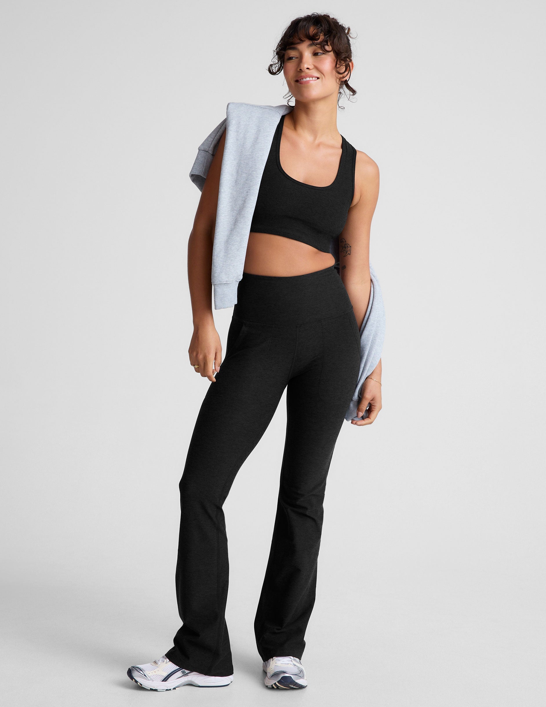 black high-waisted bootcut pants with side pockets.
