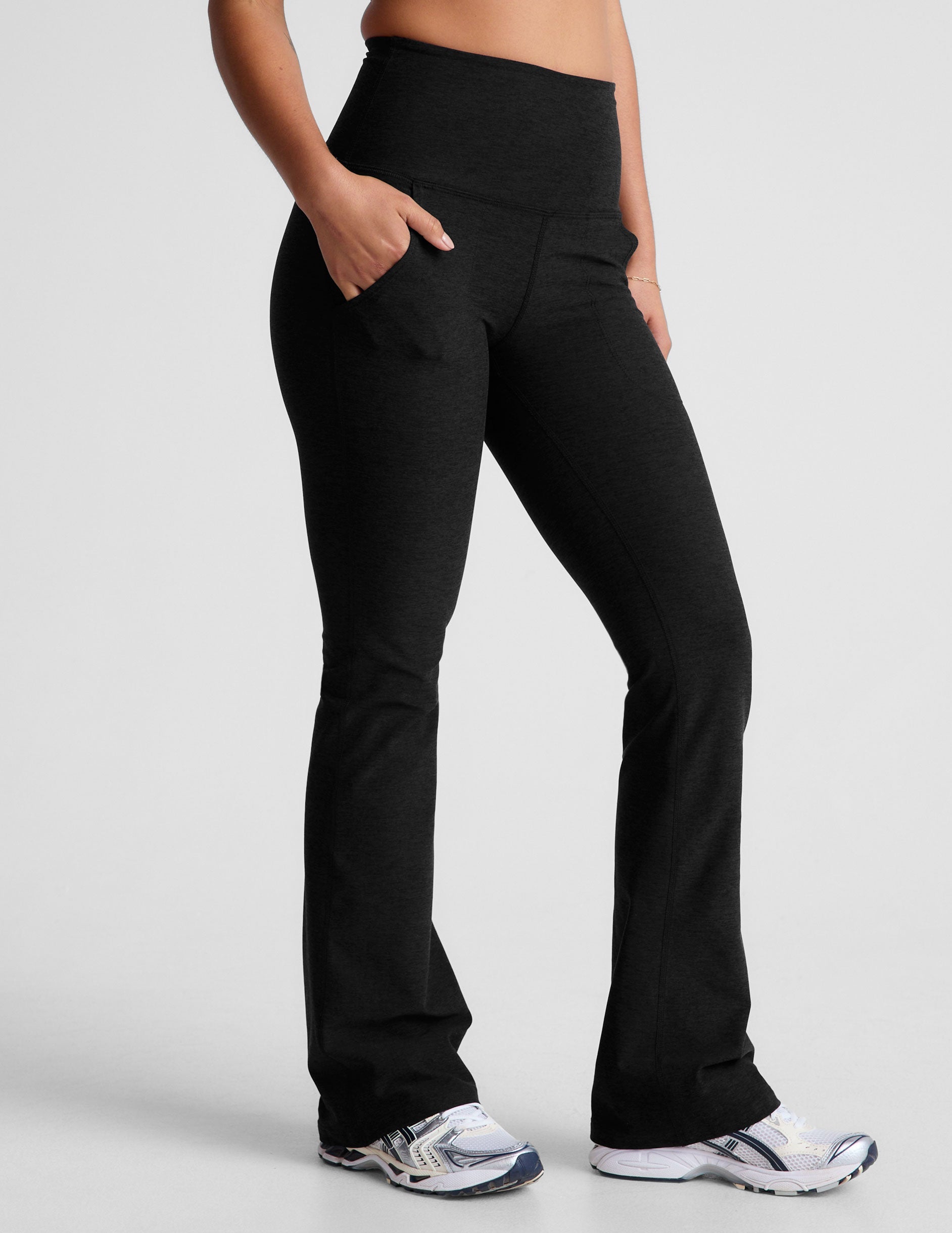 black high-waisted bootcut pants with side pockets.