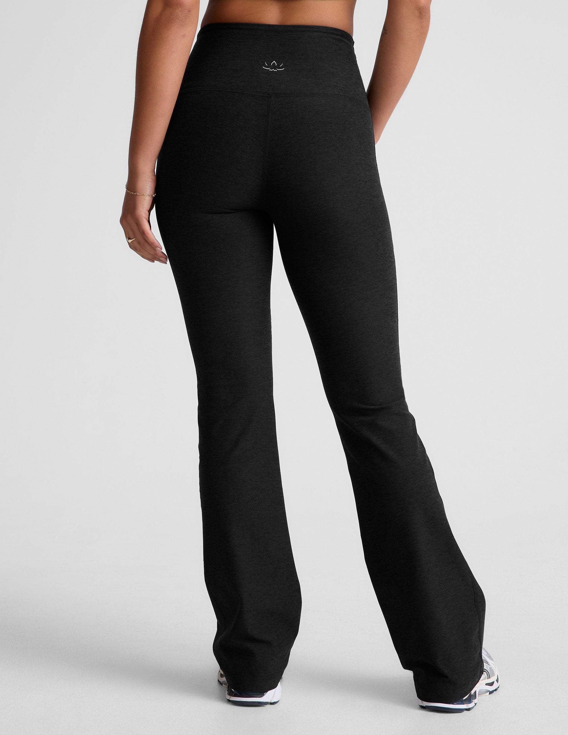 black high-waisted bootcut pants with side pockets.