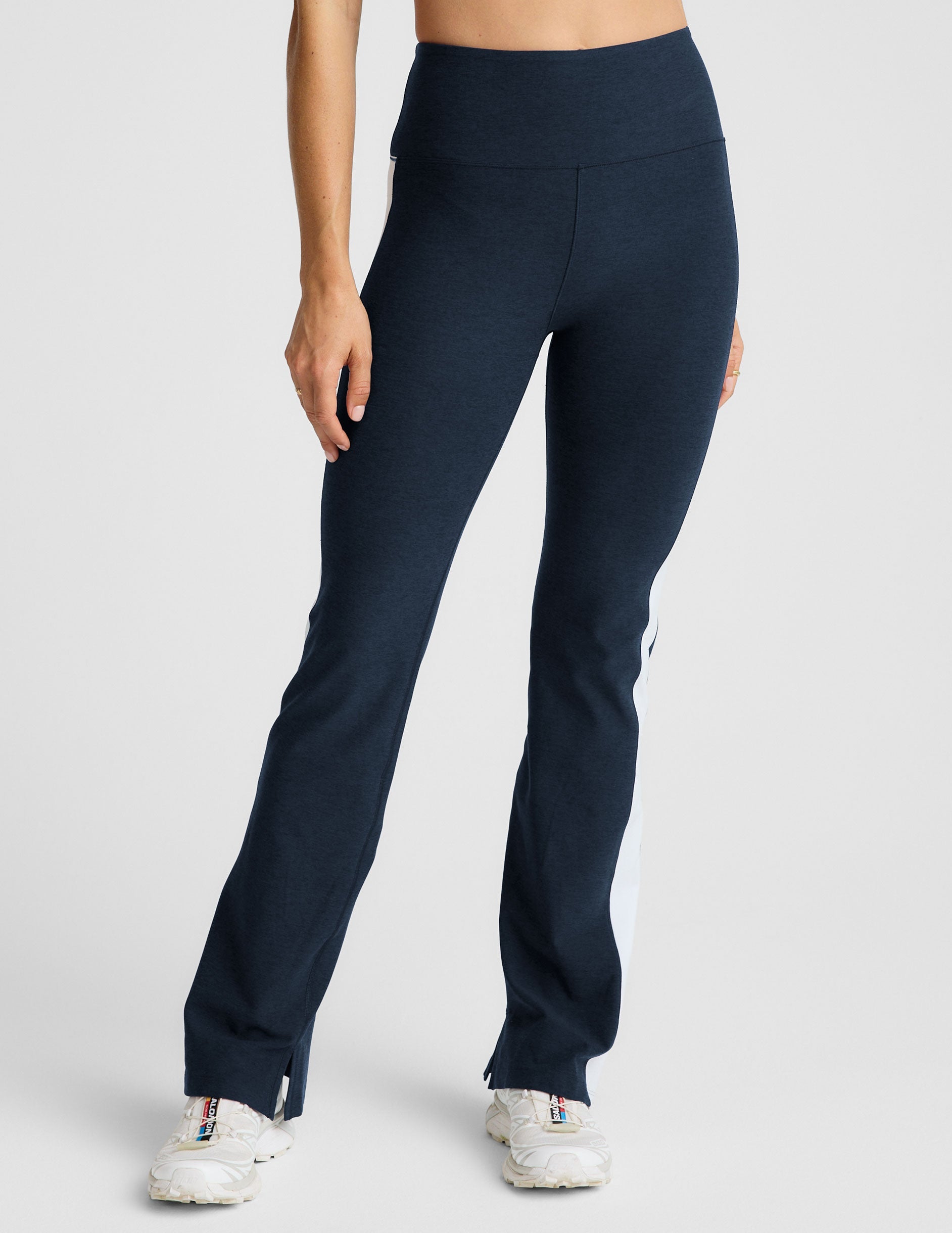 blue high-waisted bootcut pants with white contrast trim on the sides.
